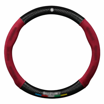 Cubre volante universal • Con logo de marca • Acabados con fibra de carbono y gamuza